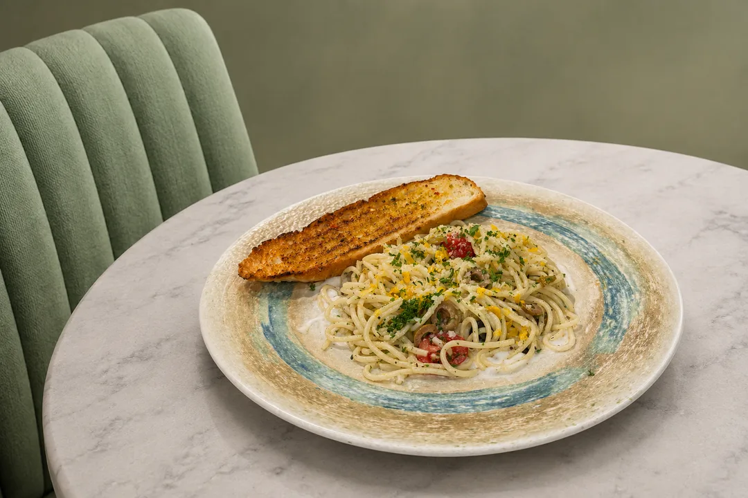 Penne pasta tossed in a velvety parmesan and roasted garlic cream sauce with fresh cracked black pepper and herbs.